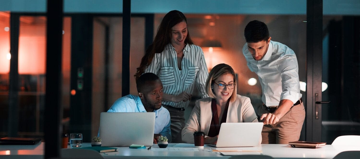 Research, laptop and business people in office at night with stock market charts for corporate investment Discussion, computer and financial advisors working on company profit report with deadline